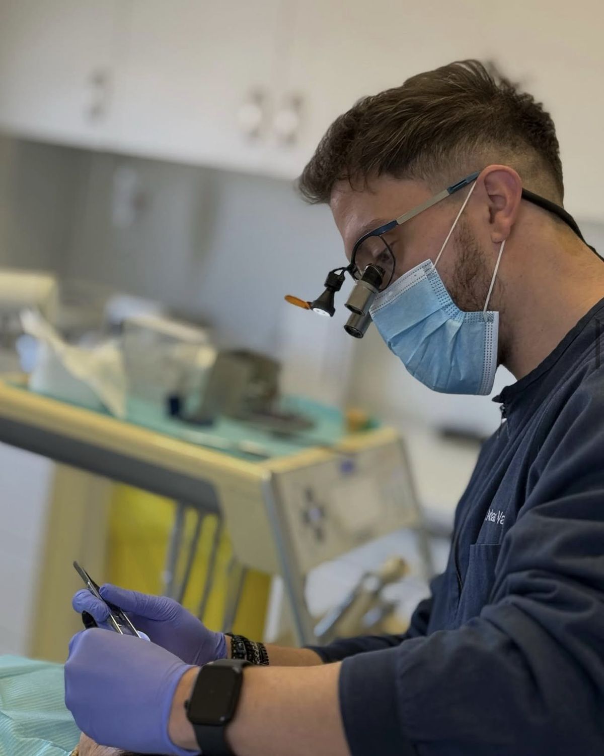 Dr Andreas Varianos working under magnification